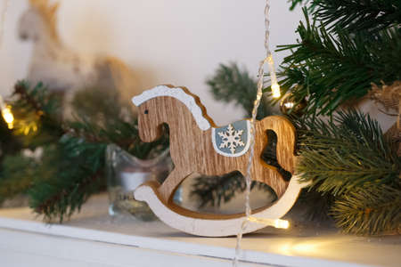Rustic Christmas wooden horse toy on wooden surface, selected focusの写真素材