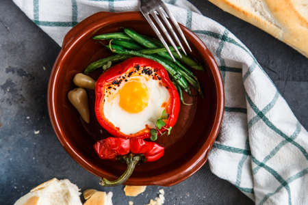 Poached egg with baked bell pepper and bread.の写真素材