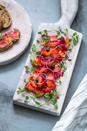 Close view of sliced gravlax, marinated salmon with salt, vodka and beetrootの写真素材