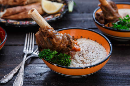 Lamb shank with puree and parsley in bowl, close viewの写真素材