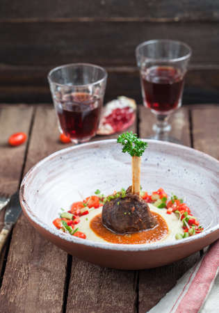 Lamb shank with eggplant puree and fresh vegs, traditional turkish dishの写真素材