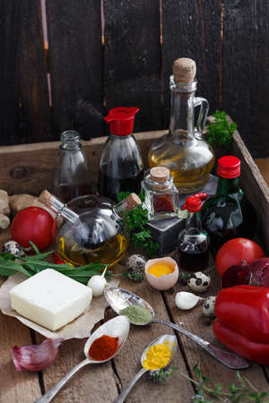Big set of sauces and spices, with vegetables in a wooden boxの写真素材