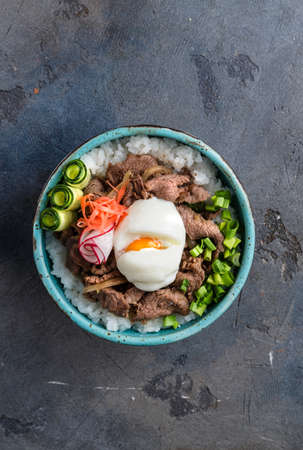 Top view beef bowl gyudon with rice and egg, copyspaceの写真素材