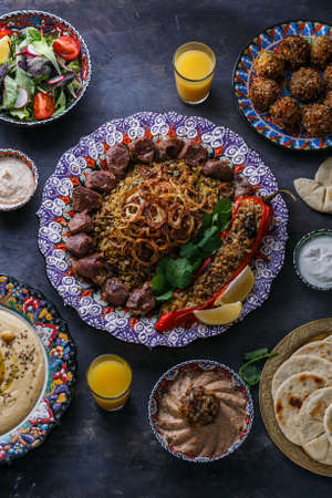 Middle eastern or arabic dishes: shish kebab, falafel, hummus, rice, tahini, kashke bademjan, pita. Top viewの写真素材