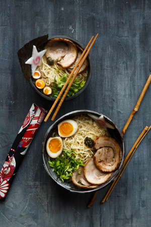 Miso ramen soup with pork, egg and chivesの写真素材