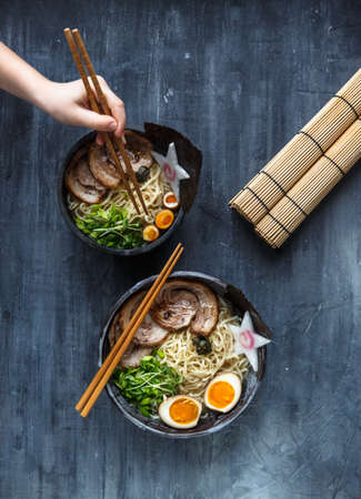 Hand with chopsticks try miso ramenの写真素材
