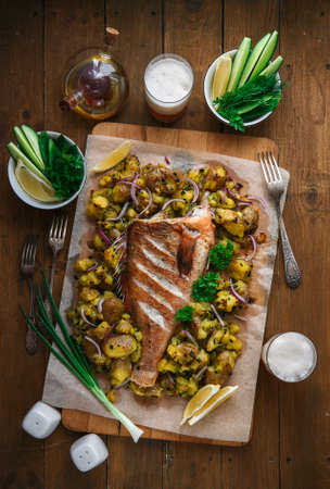 Red sea perch or red grouper baked with potatoes, top viewの写真素材