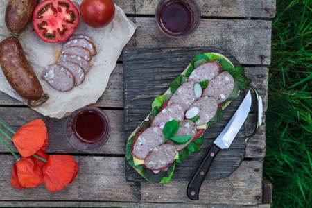 Sandwich with sausage slices, tomato and lettuce, top viewの写真素材