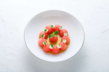Watermelon salad with feta cheese and mint with olive oil, restaurant meal.の写真素材