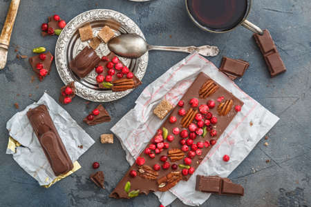 Cups of coffee with chocolate on a stone background.