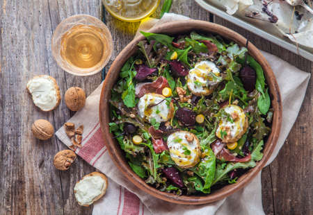 Beet and goat cheese salad in a clay pot with cider, rustic style.の写真素材