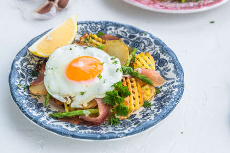Fried egg with potato and jamon ham, spain cuisine, close viewの写真素材