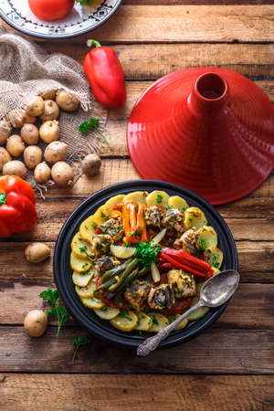 Fish tajine mqualli with potato and bell peppers, top view.の写真素材