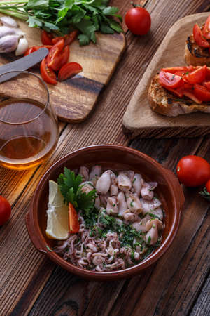 Grilled baby with garlic and lemon on wooden background