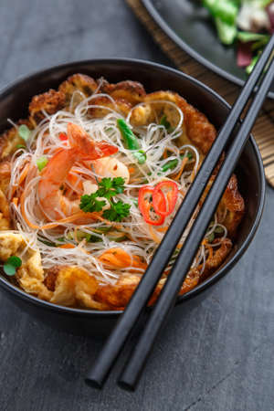 Thai omelette with spicy noodle salad on topの写真素材