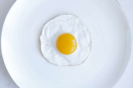Fried egg isolated on white background, top viewの写真素材