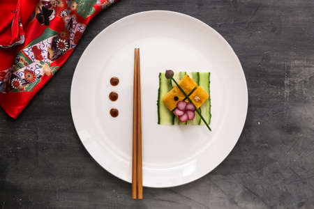Tamagoyaki on a plate, top view stone background, copy spaceの写真素材