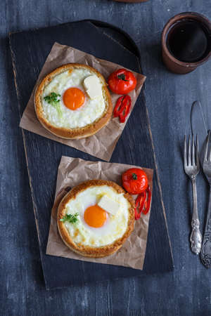 Khachapuri modern look on black wooden cutting boardの写真素材