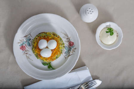Zucchini fritters, vegetarian zucchini pancakes, served with quail eggs and carrots on topの写真素材