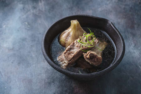 Close view of bak kut teh soup on dark background, copy spaceの写真素材