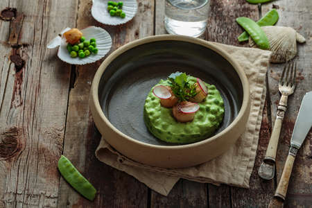 Scallops with pea puree on wooden background, rustic styleの写真素材