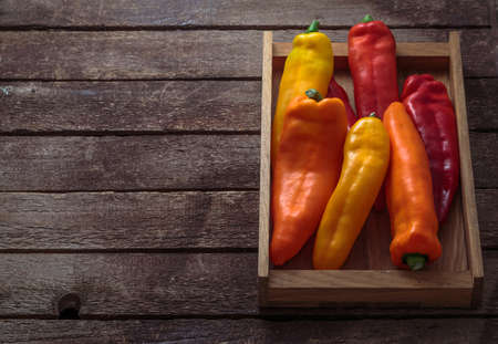Ripe Colorful Ramiro Peppers Wooden box copy space.の写真素材