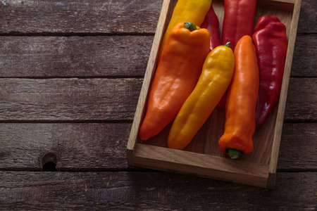 Ripe Colorful Peppers on Wooden background, copy space.の写真素材