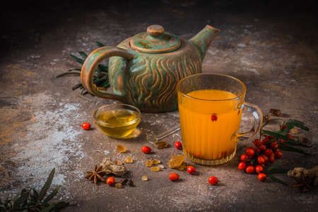 Autumn berry tea in glass cup with tea potの写真素材