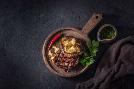 Two beef steaks with crispy chips and chilli pepperの写真素材