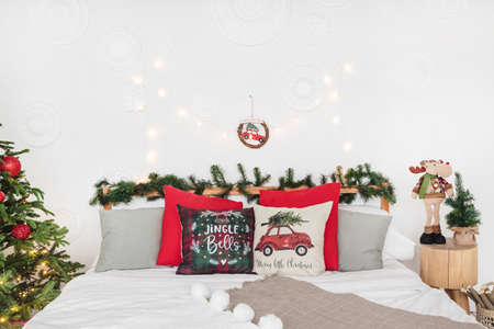 Bed with pillows with red Christmas decorの写真素材