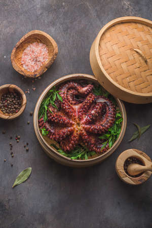 Big octopus in steamer with spices and herbs, close viewの写真素材