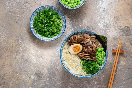 Shio ramen soup with chicken, mushrooms, onion and egg, flat lay copy space
