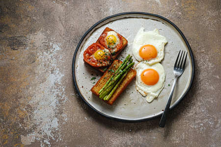Breakfast with asparagus, eggs and tomato, copy space.の写真素材