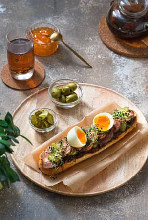 Homemade sandwich with turkey, pickles and egg for breakfast, copy spaceの写真素材