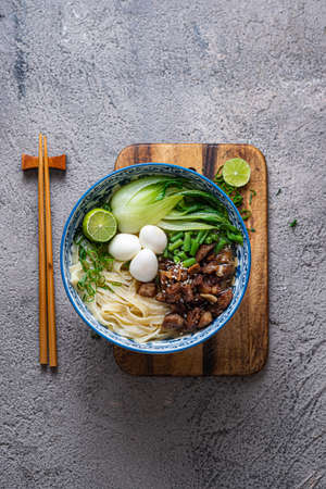 Japanese ramen soup with chicken, egg, chives and bok choy on concrete background.の写真素材