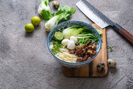 Japanese ramen soup with chicken, egg, chives and bok choy on concrete background.の写真素材