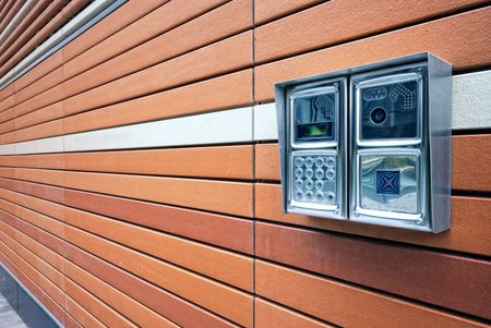 Shiny stainless steel intercom at a modern apartment block. 