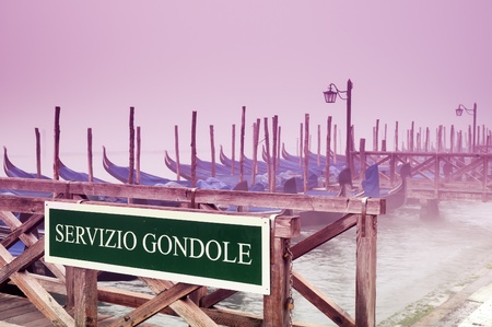 Gondolas in the morning fog in Venice の写真素材