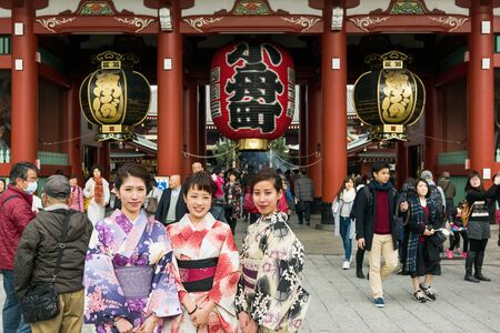 Tokyo; Japan -January  07: Large crowd including a group of friends wearing a traditional Japanese kimono  at the Hozomon Gate at Senso-ji Temple Asakusa, Tokyo.のeditorial素材