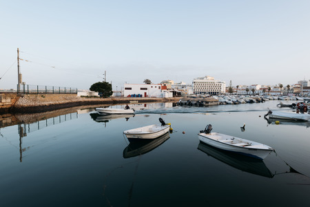 Faro - Portugal, April 4, 2018:  Fisherman silling out for work at the early morning at the Faro...