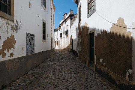 Faro - Portugal, April 3, 2018: Narrow street in the old town of Faro, Algarve, Portugal.のeditorial素材