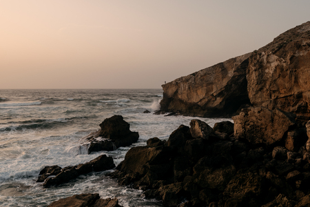 A lonely fisherman at Monte Clerigo Beach, Algarve, Portugal