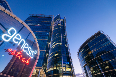 Warsaw, Poland - Oct 21, 2018: Office building Warsaw Spire at Night and the neon sign of a popular steak restaurant called Genesis, Warsaw, Poland.のeditorial素材