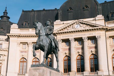 Bucharest, Romania - Dec 15, 2019: Central University Library of Bucharest, and King Carol I statue,...