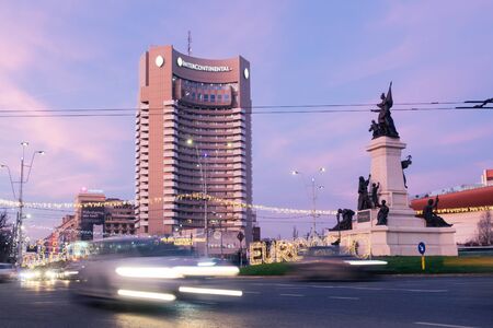 Bucharest, Romania - Dec 16, 2019:  Rush hour in Universitatii Square, in downtown Bucharest at dusk; Intercontinental Hotel and the Bucharest National Theater (TNB) in the backgroundのeditorial素材