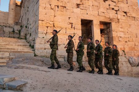 Athens, Greece - Dec 20, 2019: Greek soldiers march in formation while on patrol at the Acropolis of Athens.  Soldiers go to Acropolis to lower a Greek flag every evening.のeditorial素材