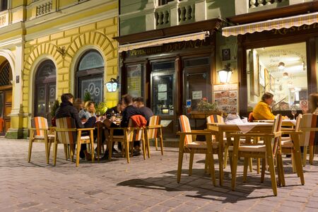 Brasov, Romania - Nov 10, 2019: Republicii street, the main pedestrian and shopping street in Brasov, full of restaurants. Brasov, Romaniaのeditorial素材