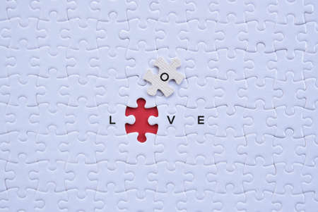 'Love' saperated alphabet on white puzzles with red blank background flat lay concept.の写真素材