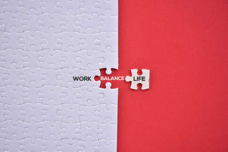 'Work balance life' word on white puzzles and red background flat lay concept.