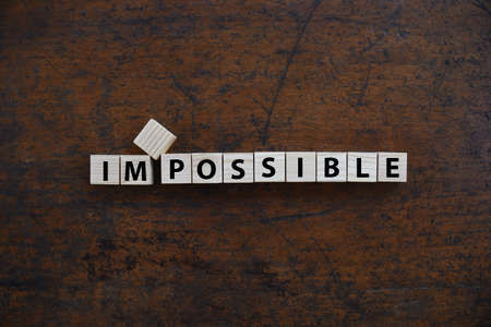 Change to IMPOSSIBLE to I'M POSSIBLE word on wood block.